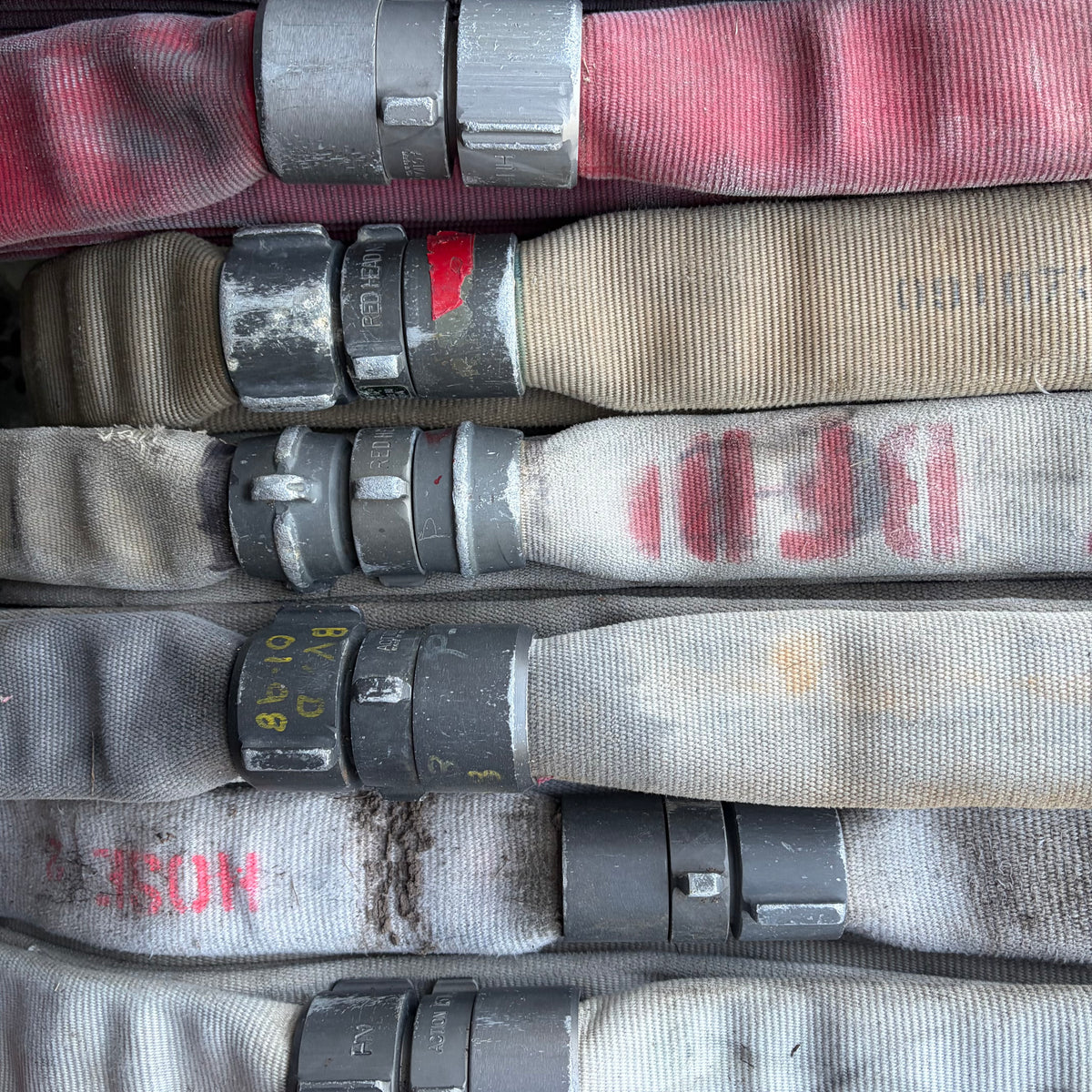 Fire hose is built to hold water at pressure and to be dragged across gravel and glass. It does not tear, fray or rot. We think that is worth hanging on a wall.